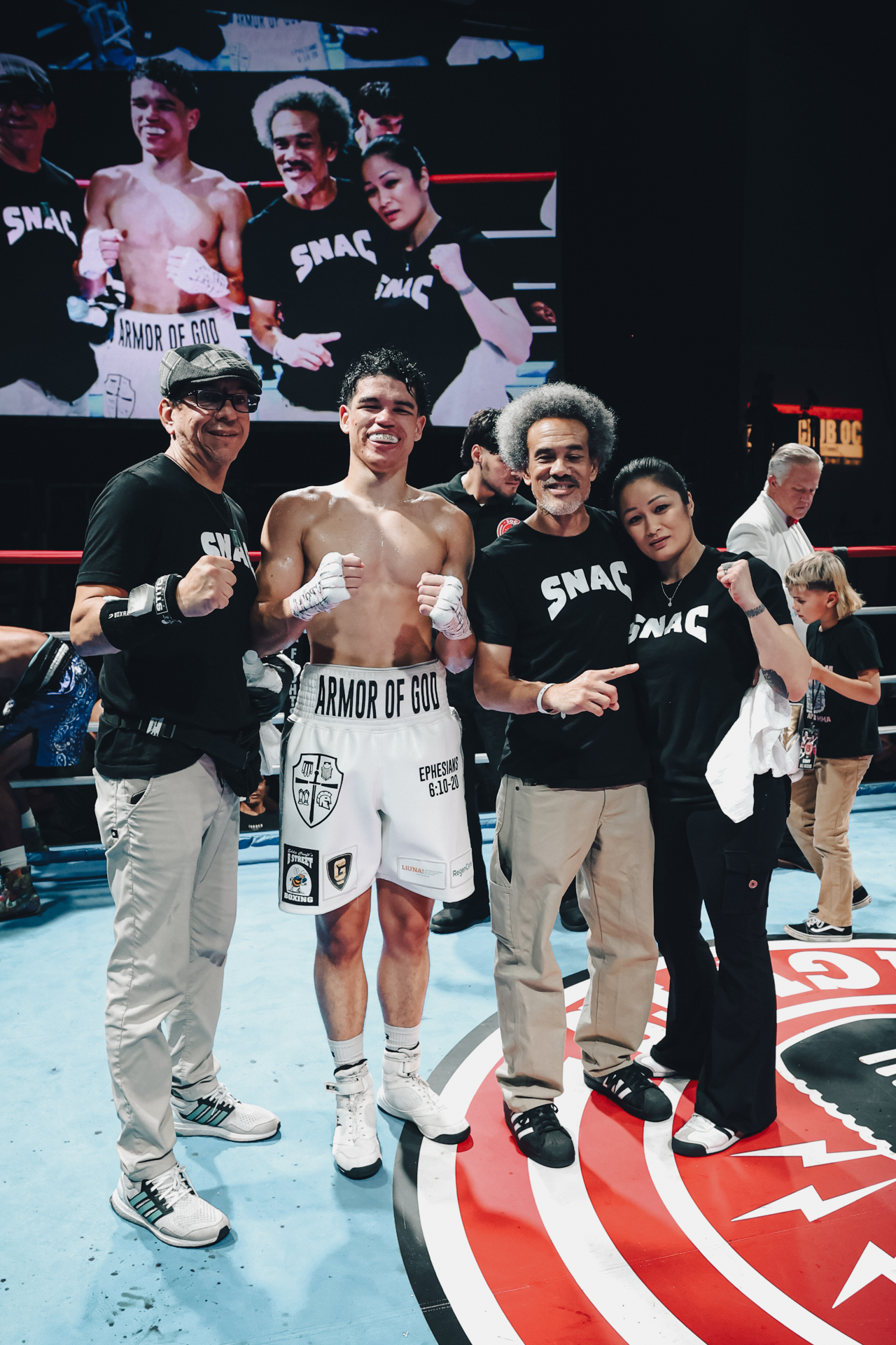 Post-fight team photo in the ring