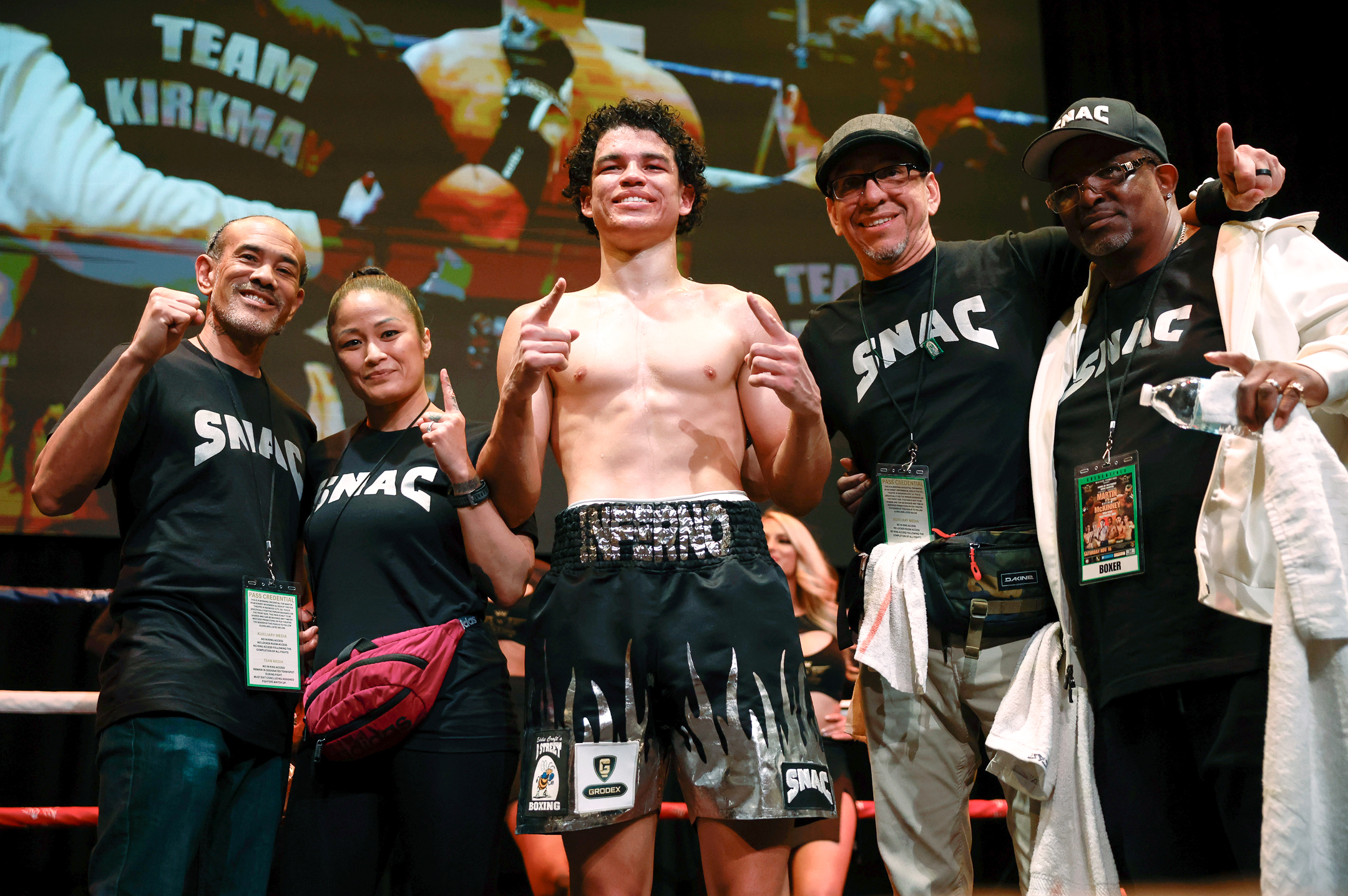 Post-fight team photo in black shirts