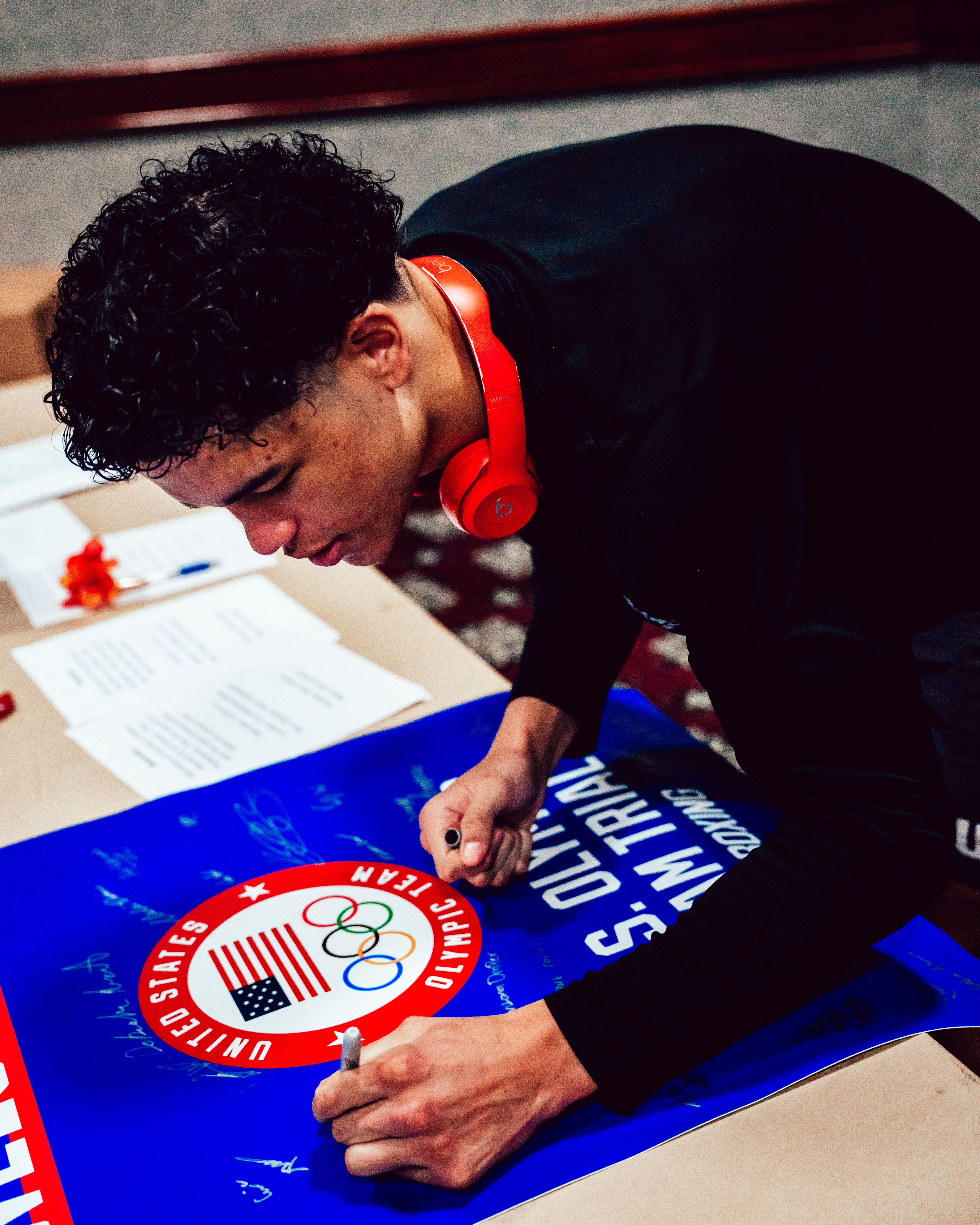 Dante signing a U.S. Olympic Team Trials poster