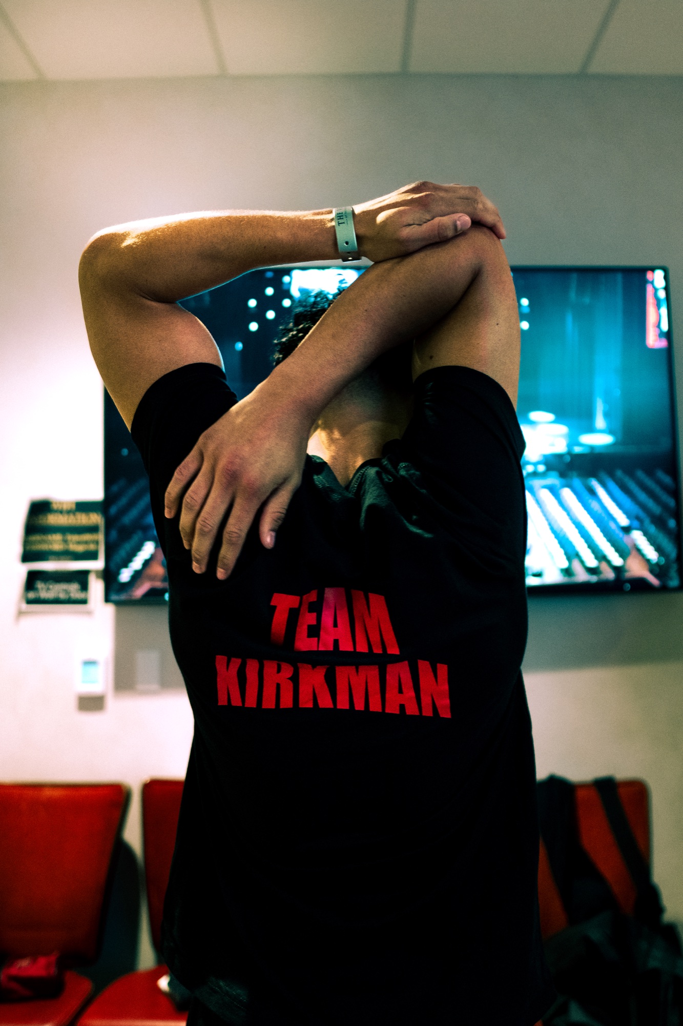 Dante Kirkman stretching in a black Team Kirkman shirt